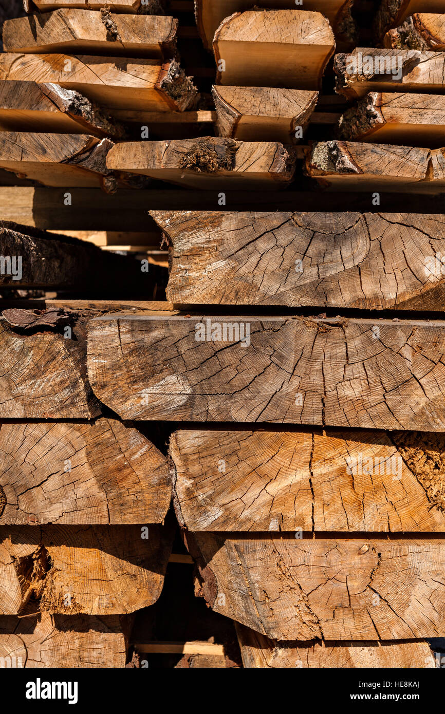 Image of stacked wooden balks and boards in a sawmill. Stock Photo