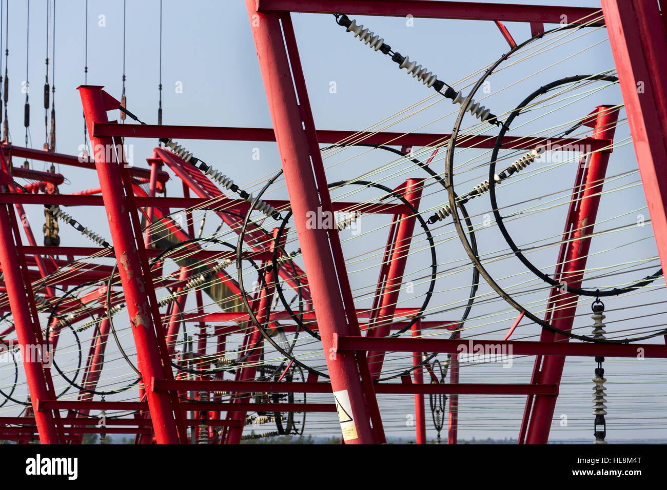 Communication wires lead to switching station from radio transmitter tower Stock Photo