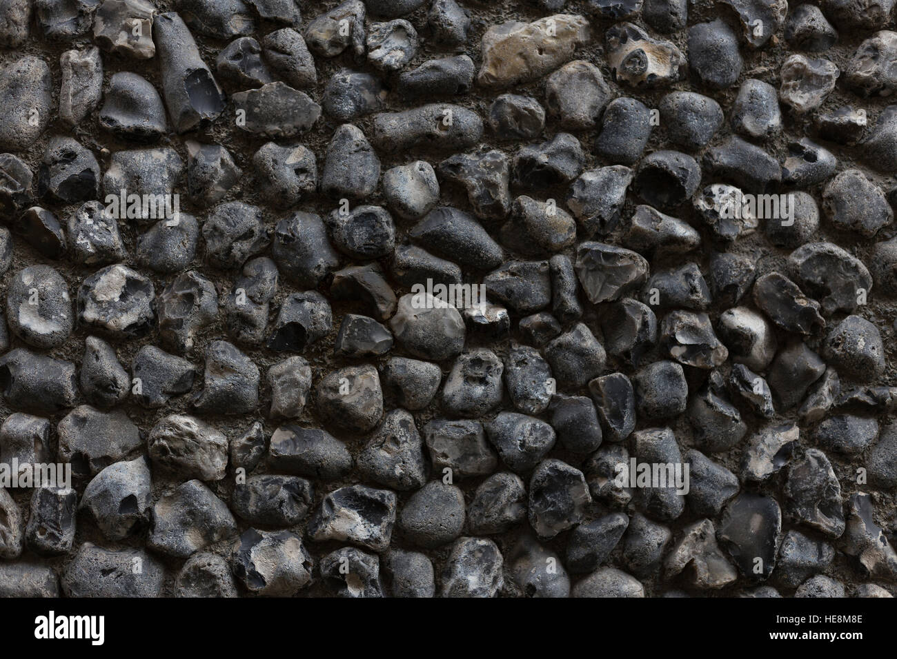 Close-up of building with textured, coarse grey, black and white pebbledash exterior wall treatment Stock Photo