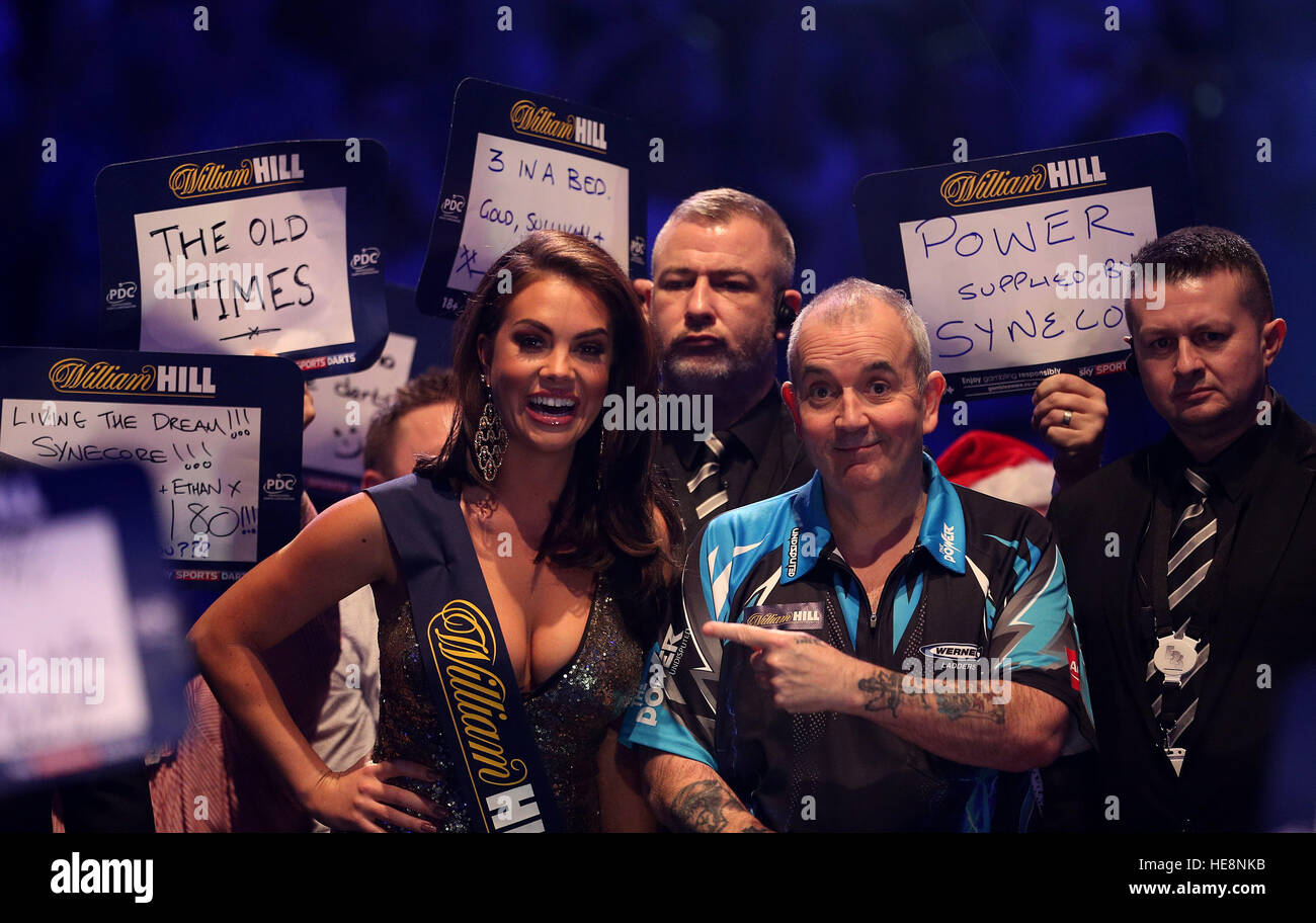 Phil Taylor and a William Hill oche girl during the walk on during day four  of the William Hill World Darts Championship at Alexandra Palace, London  Stock Photo - Alamy