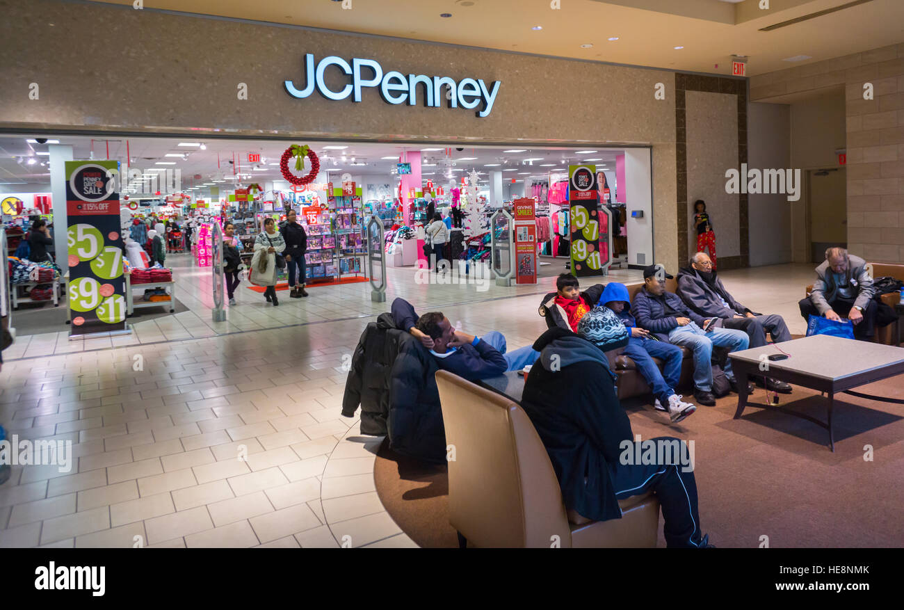 Shoppers rest outside the JCPenney department store in the Queens