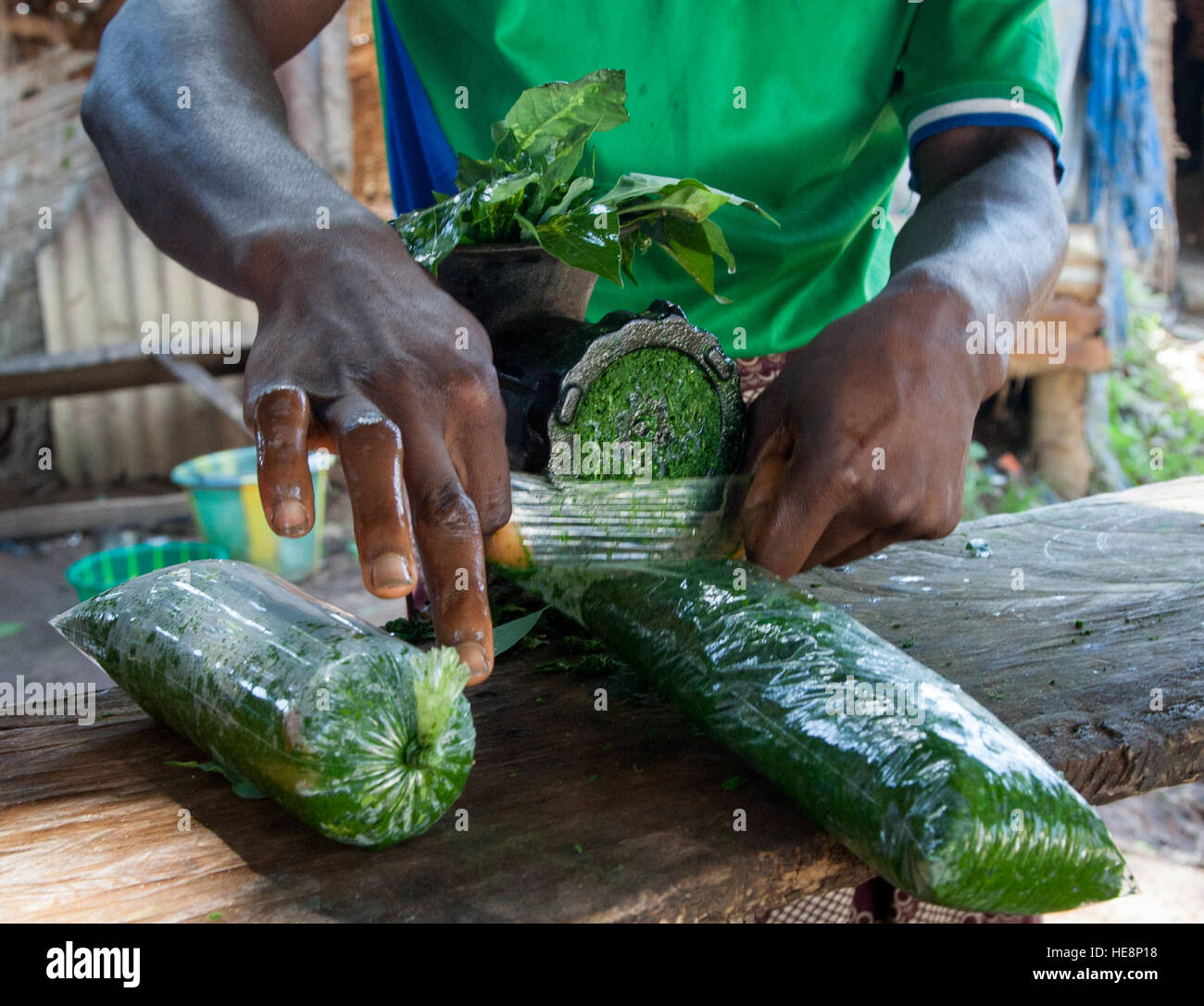 Cassava leafs beeing minced on market in Kabala, Sierra Leone Stock Photo