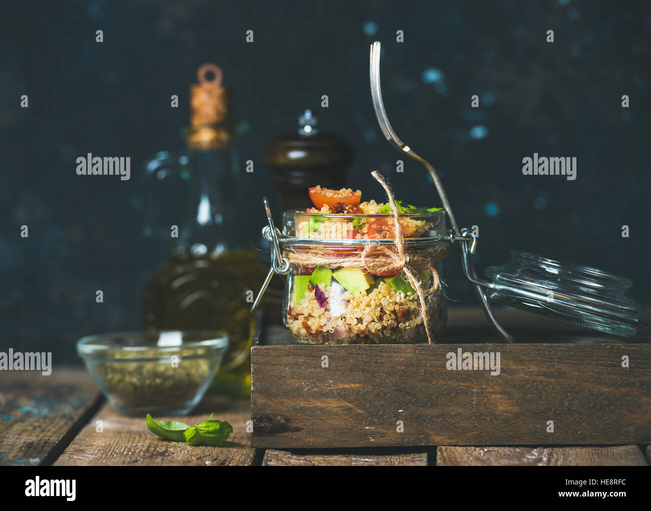Healthy homemade jar quinoa salad with sun-dried tomatoes, avocado, basil Stock Photo