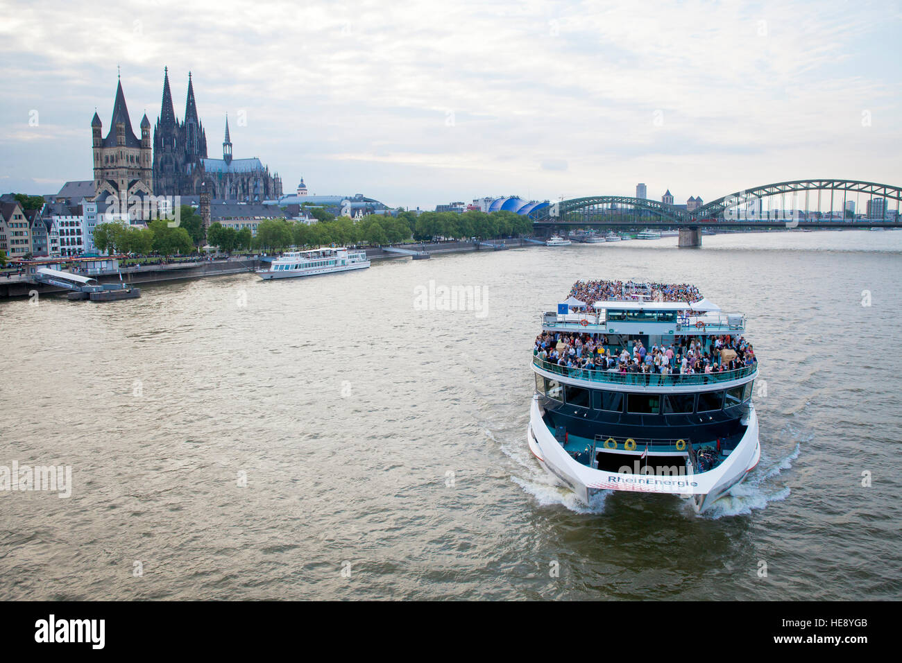 Germany, Cologne, the event ship RheinEnergie, river Rhine, Cologne cathedral an church Gross St. Martin. Stock Photo