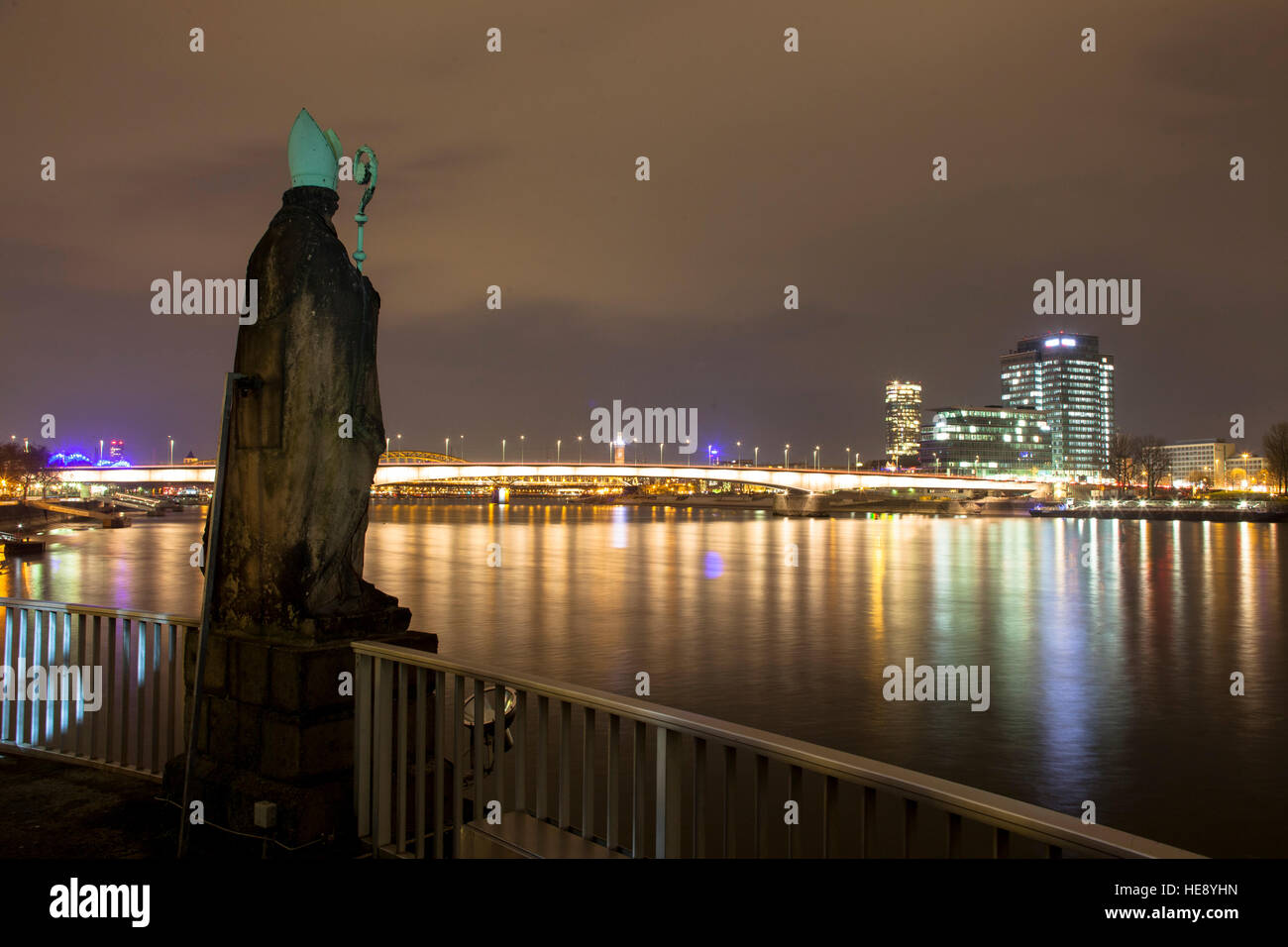 Germany, Cologne, St. Nikolaus statue at the Rheinau harbour, view across the river Rhine to the district Deutz Stock Photo