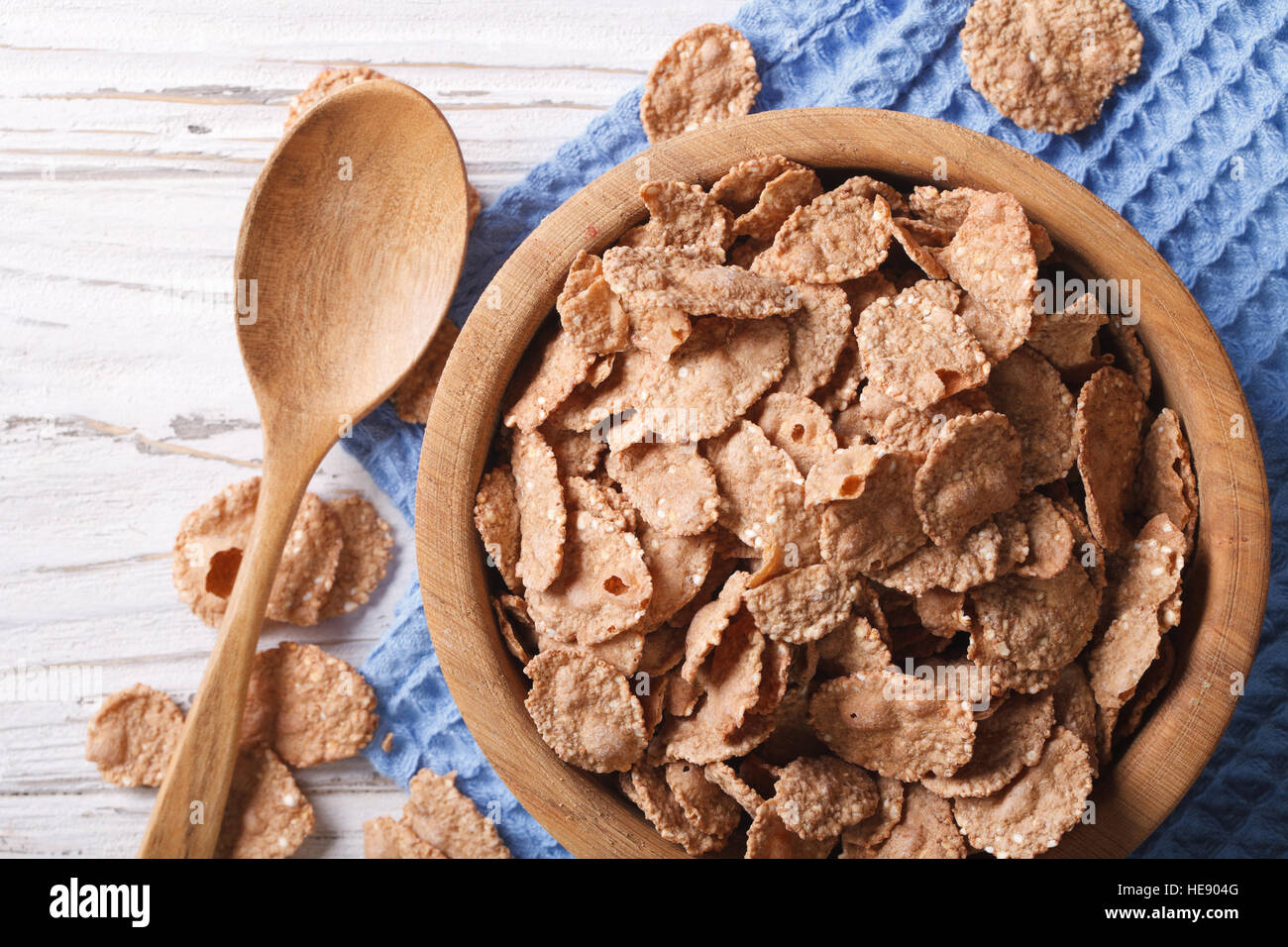 cereal flakes in a wooden bowl closeup. horizontal top view, rustic style Stock Photo