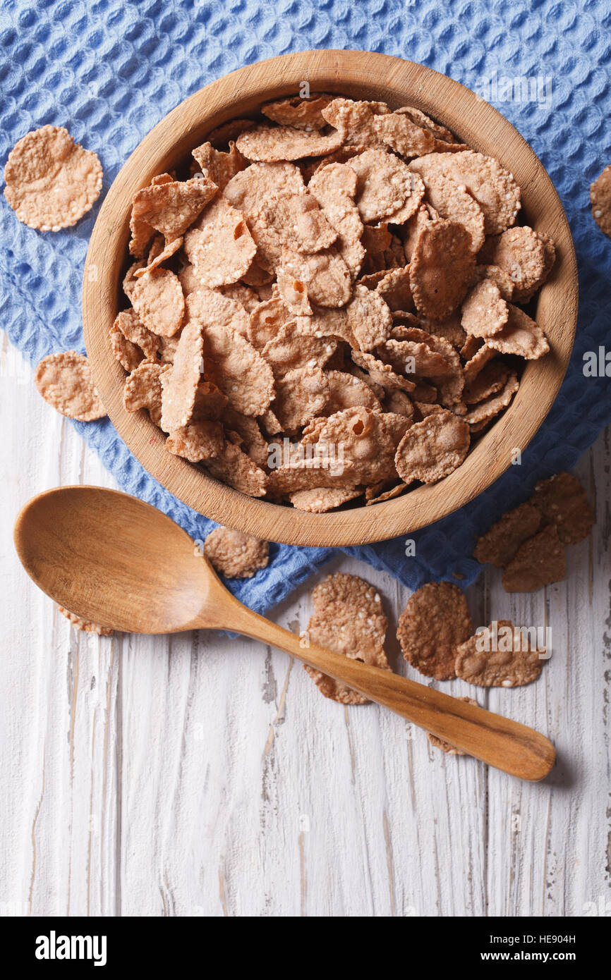 cereal flakes in a wooden bowl. vertical top view, rustic style Stock Photo