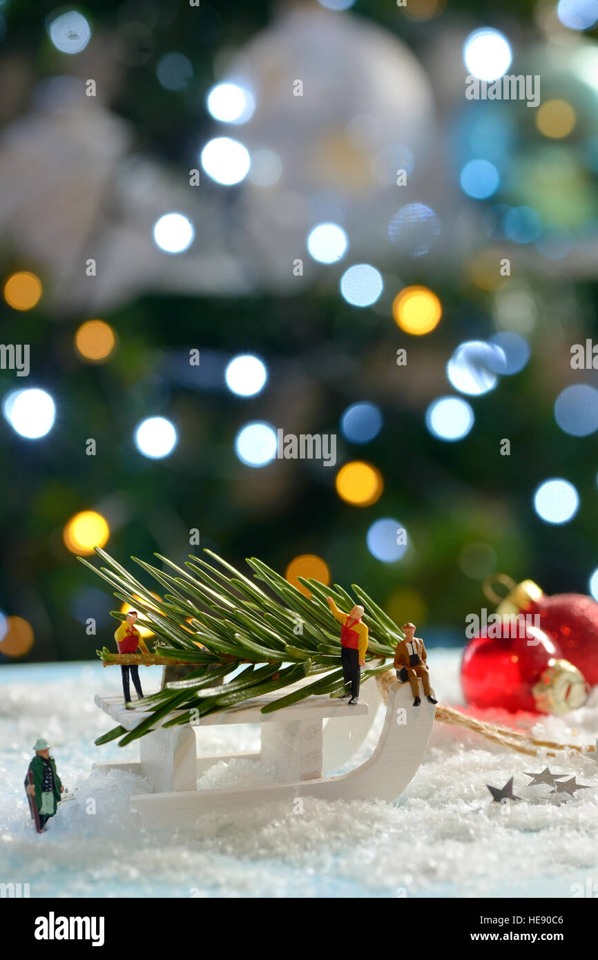 Christmas tree and sleigh decoration with figurines on fake snow Stock Photo