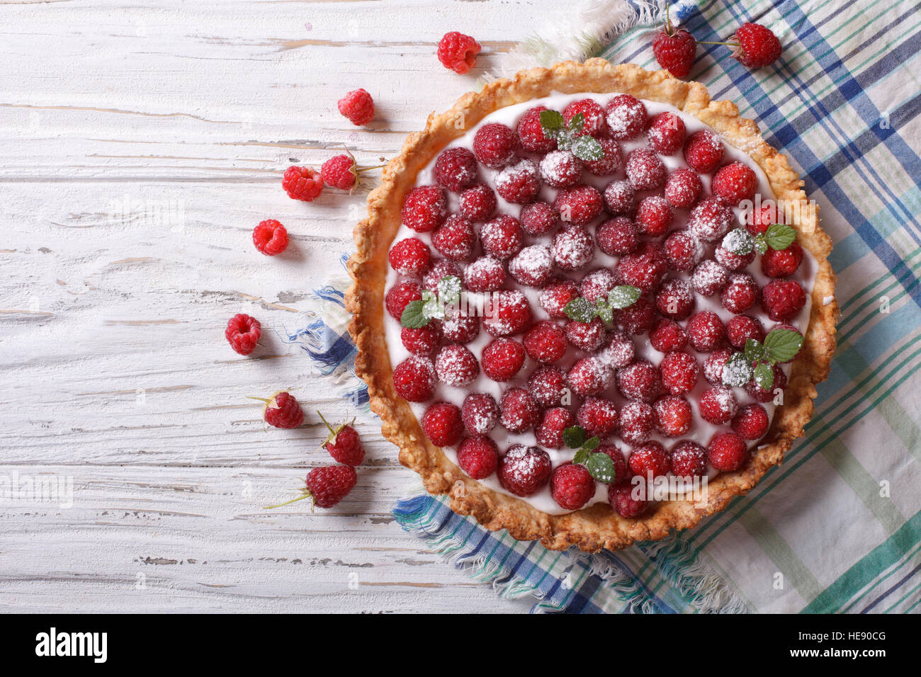 Fresh raspberry tart with cream cheese and mint. horizontal top view Stock Photo