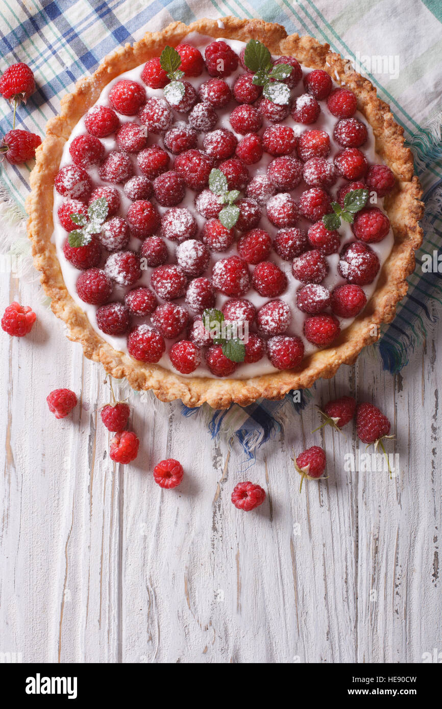 Fresh raspberry tart with cream cheese and mint. vertical top view Stock Photo