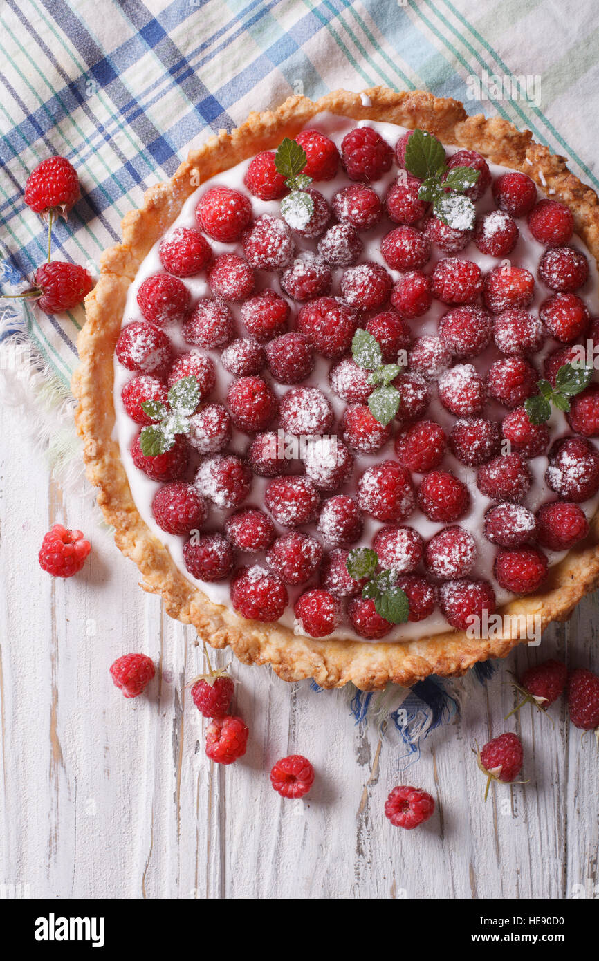 Fresh raspberry tart with cream cheese and mint closeup. vertical top view Stock Photo