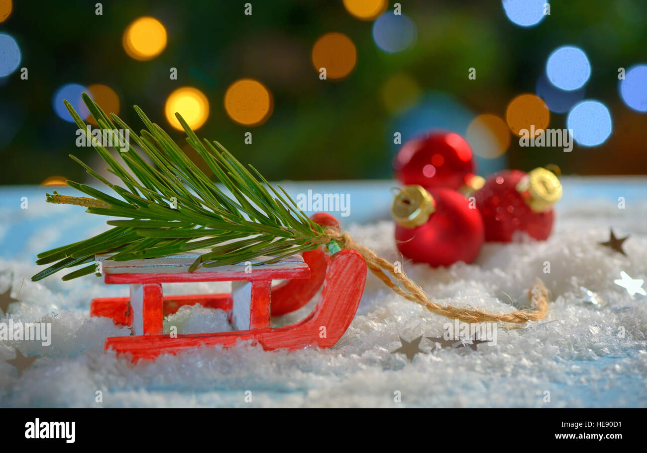 Christmas tree and sleigh decoration on fake snow Stock Photo