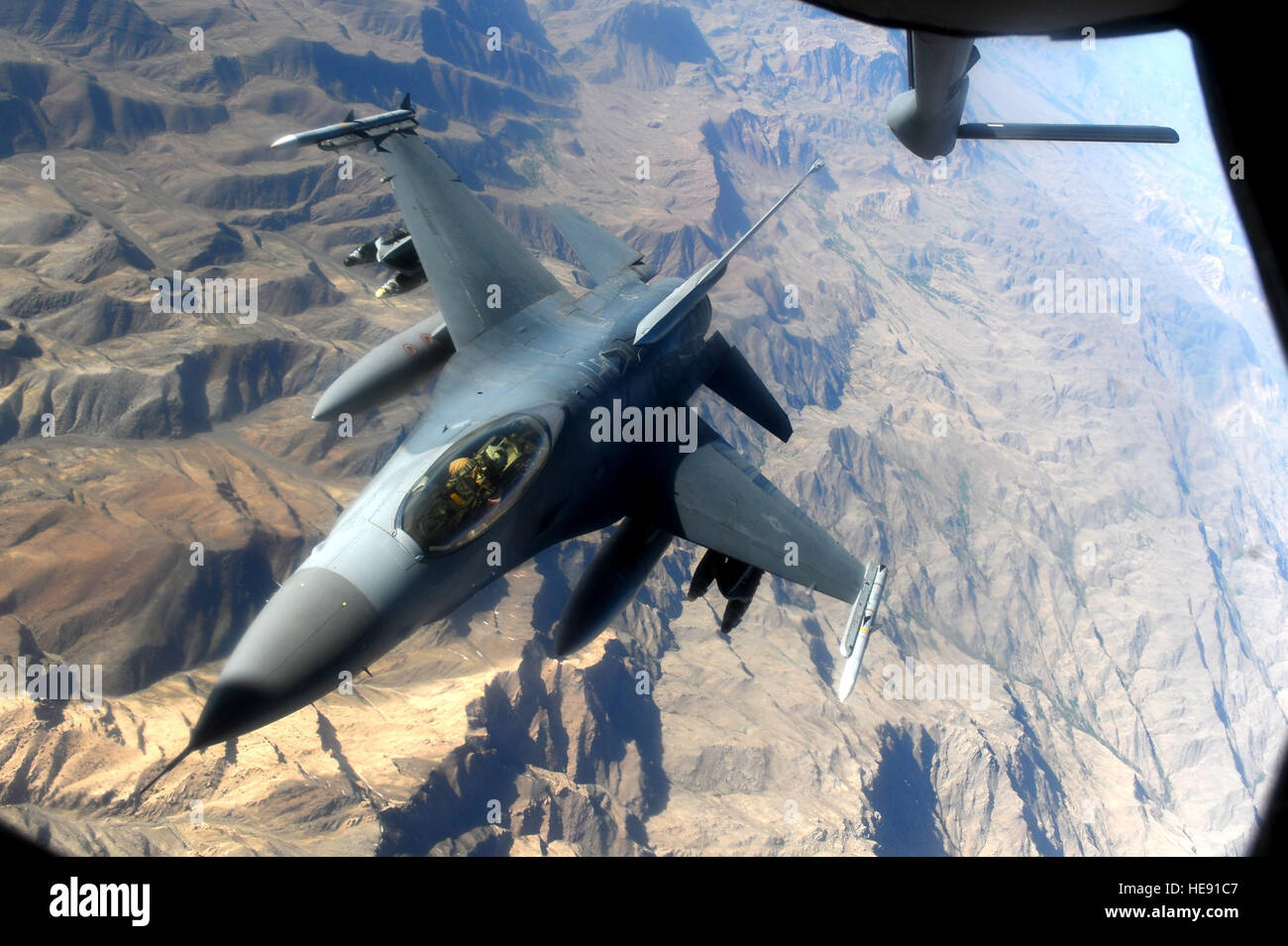 A F-16 Fighting Falcon, from the 555th Expeditionary Fighter Squadron, returns to mission after being refueled by a KC-135 Stratotanker, from the 340th Expeditionary Air Refueling Squadron, during an air refueling mission in the skies of Afghanistan supporting Operation Enduring Freedom, May 12, 2011.  Master Sgt. William Greer) Stock Photo