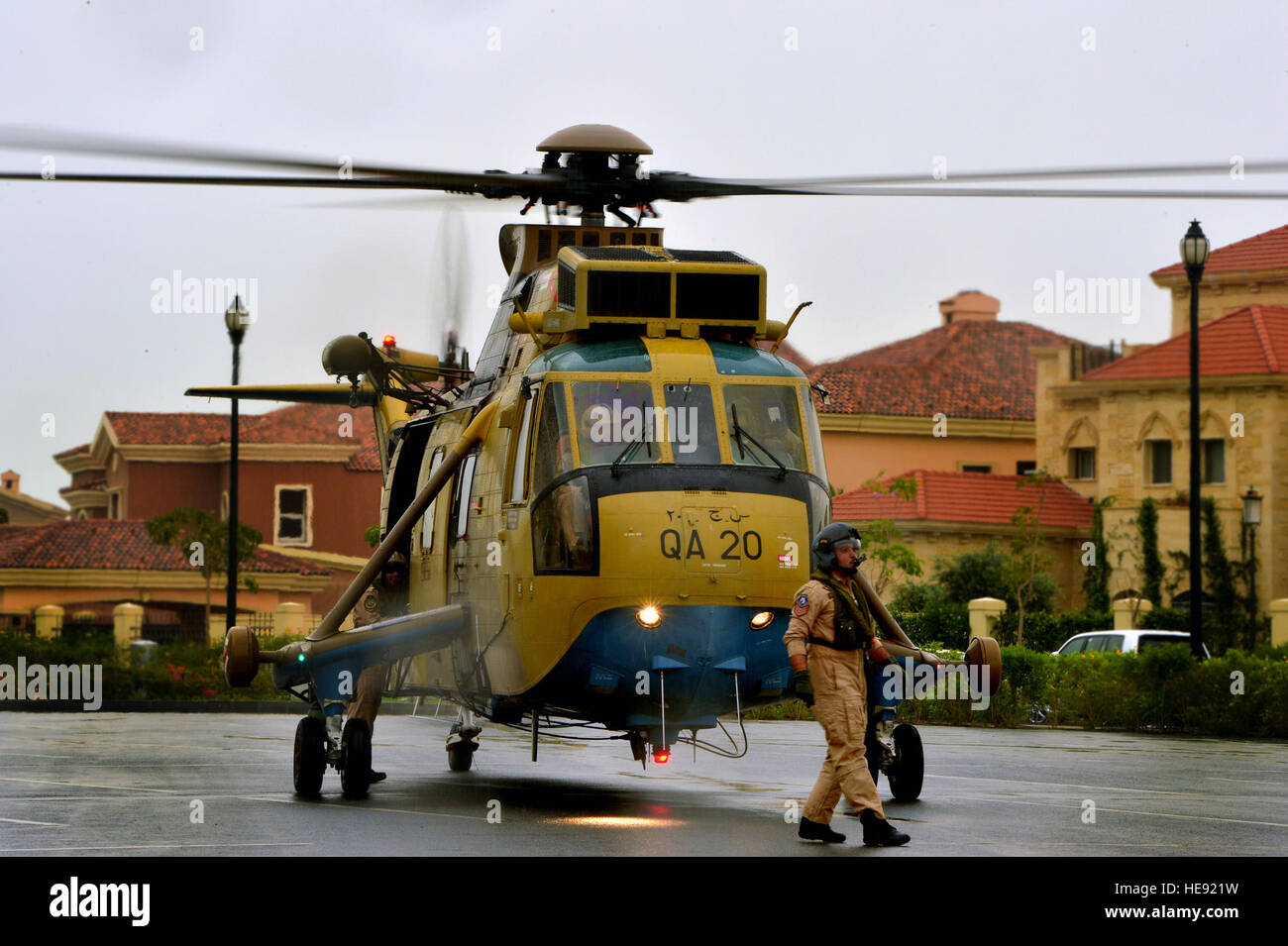 A Qatar armed forces helicopter pilot walks across a helicopter landing
