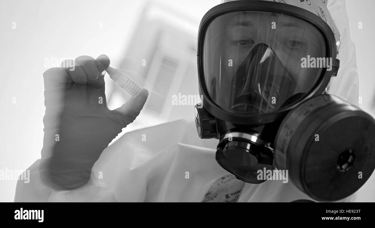 Staff Sgt. Daniel Burdick, 97th Medical Operations Support Squadron bioenvironmental engineering flight entry team member, runs a test on contaminants found in a simulated contaminated area as part of the all hazards chemical, biological, radiological and nuclear response (ACR) training, July 25. The Altus AFB ACR team ensure that responders who go in harm's way are protected and anything potentially criminal is investigated properly in line with crime scene evidence collection processes.  Senior Airman Jesse Lopez / Released) Stock Photo