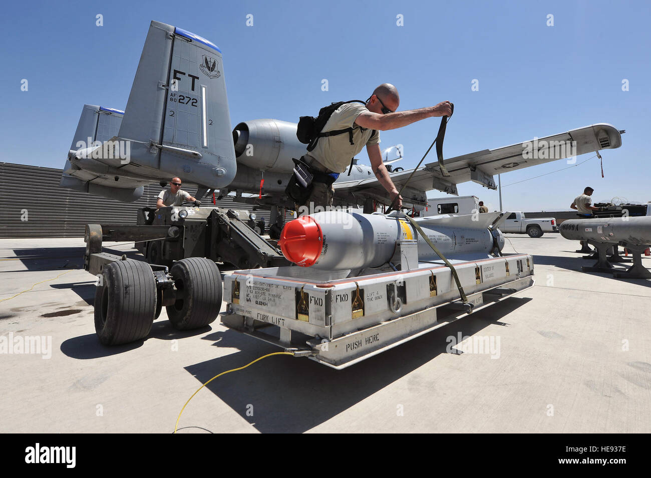Weapon loaders from the 74th Expeditionary Fighter Squadron prepare to load ammunition onto an A-10 Thunderbolt II on Bagram Air Field, Afghanistan, May 8, 2013. The aircraft can deploy general purpose bombs, cluster bomb units, laser guided bombs, joint direct attack munitions, wind corrected munitions dispenser, AGM-65 Maverick and AIM-9 Sidewinder missiles, rockets, illumination flares, and the GAU-8/A 30mm cannon, capable of firing 3,900 rounds per minute.  Senior Airman Chris Willis) Stock Photo