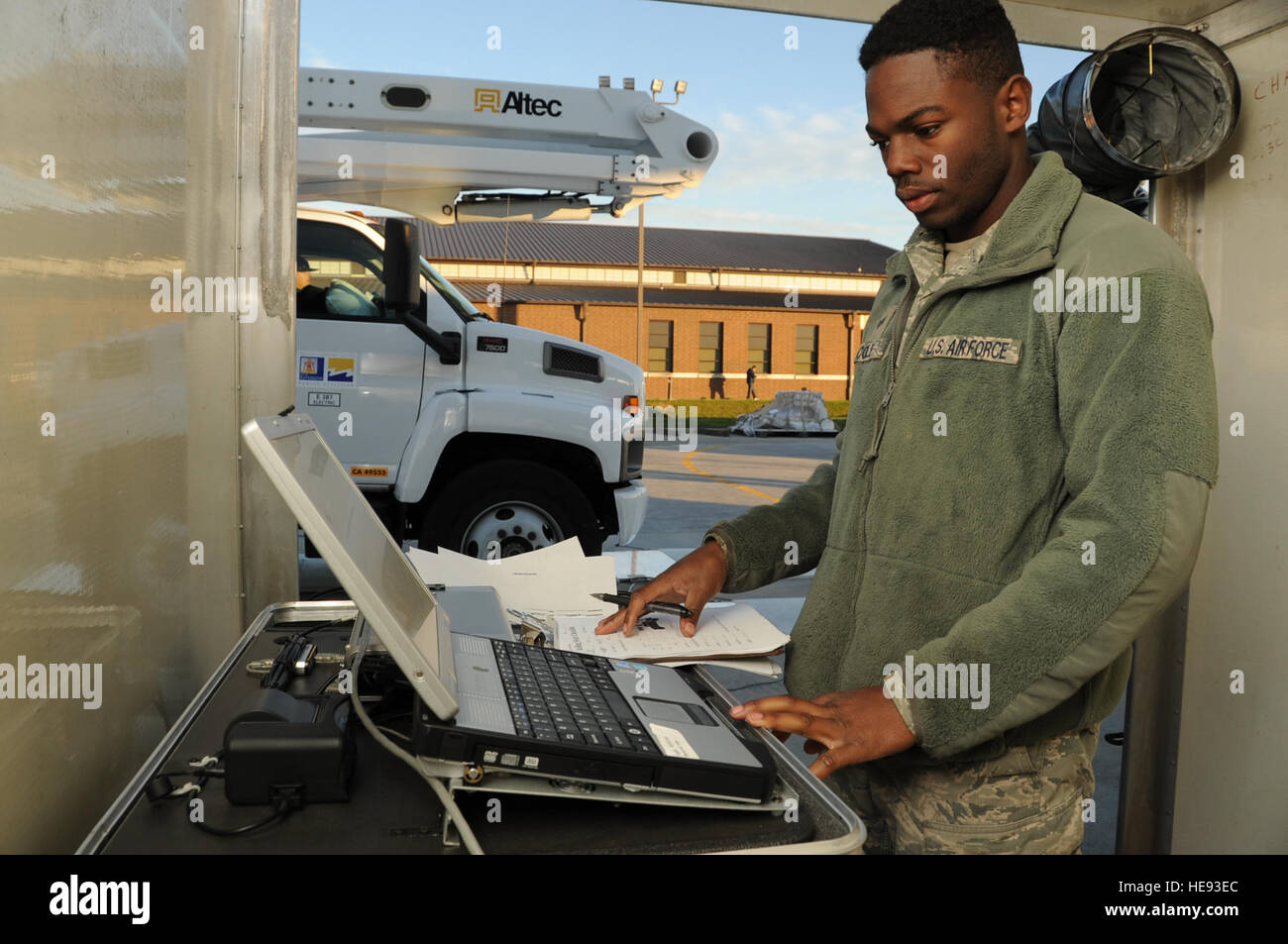 Senior Airman Marquis Cole, 305th Aerial Port Squadron aerial transportation specialist, monitors a Deployable Automated Cargo Measurement System computer, Nov. 16, 2012, as a utility and line truck passes through DACMS at Joint Base McGuire-Dix-Lakehurst, N.J., to determine if the truck's approximate size and weight. Cole is an Independence, La., native.  Staff Sgt. David Carbajal Stock Photo