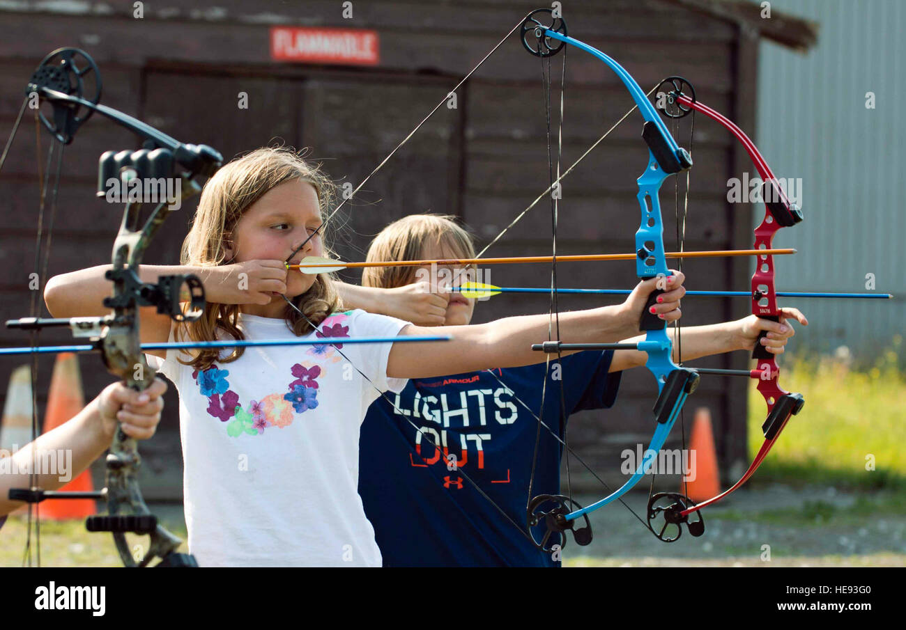 Eden (front) and Gavin Warner, children of 1st Sgt. Ryan Warner, of the 2nd Battalion, 377th Parachute Field Artillery Regiment, take aim at a target at the Skeet, Trap, and Archery Range on Joint Base Elmendorf-Richardson, Alaska, June 15, 2015. Both children participated in the archery class offered by the JBER Youth Center last summer. Staff Sgt. Sheila deVera) Stock Photo