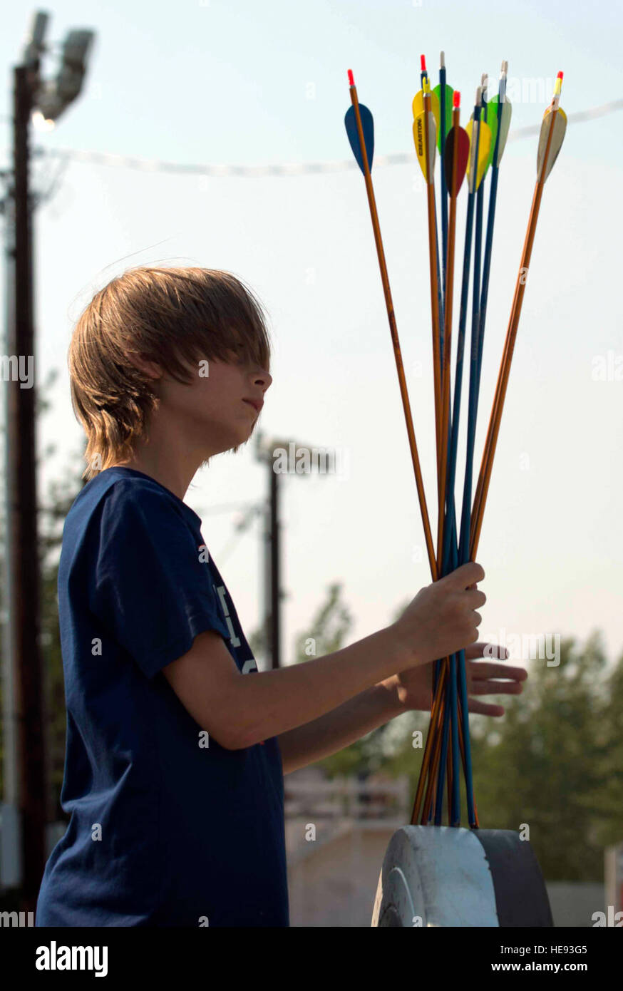 Gavin Warner, 10, secures a group of arrows before transferring them into a ground quiver during an archery class at the Skeet, Trap and Archery Range on Joint Base Elmendorf-Richardson, Alaska, June 15, 2015. The class teaches students proper safety procedures and basic archery skills. Gavin is the son of 1st Sgt. Ryan Warner, assigned to the 2nd Battalion, 377th Parachute Field Artillery Regiment, 4th Brigade Combat Team (Airborne), 25th Infantry Division. Staff Sgt. Sheila deVera) Stock Photo