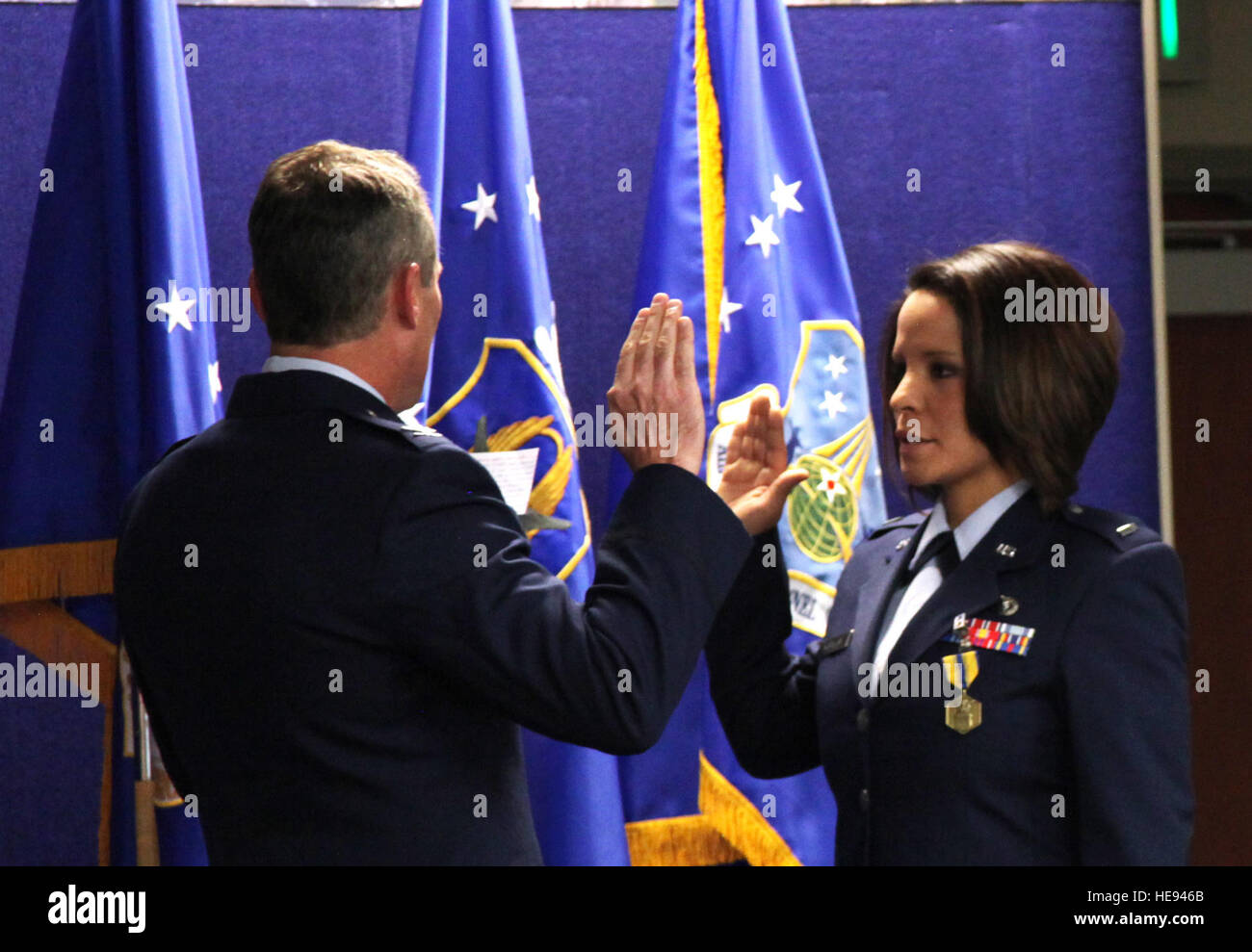 First Lt. Iris Morales, Medical Service Corps officer and former Air Reserve Personnel Center contact center noncommissioned officer, is administered the Oath of Office by Col. Pat Hayes, Total Force Service Center director, during a commissioning ceremony held Jan. 30, 2015, on Buckley Air Force Base, Colo. Tech. Sgt. Rob Hazelett) Stock Photo