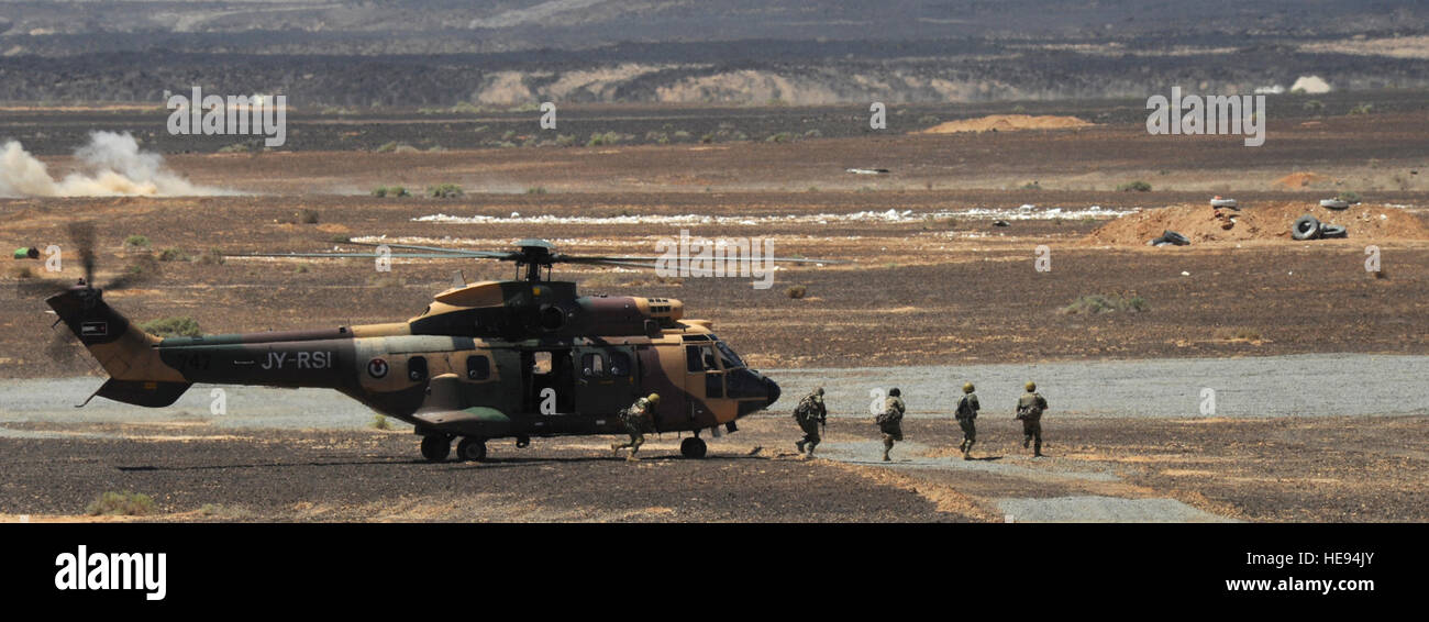 Jordanian special operations forces service members exit a Royal Jordanian  Air Force AS332 Super Puma helicopter during a first-run attack competition  as part of Eager Tiger 2014 at an air base in