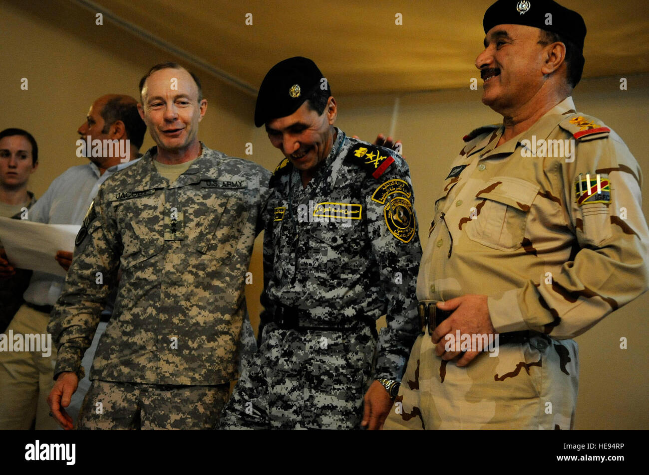 U.S. Army Lt. Gen. Charles Jacoby, Commander, Multi-National Corps - Iraq, Gen. Hussen Al Auadi, Commander, Iraqi federal police, and Gen. Ali Ghaidan, commander of the Iraqi army's ground forces, enjoy a laugh during an awards ceremony at Forward Operating Base Diamondback in Mosul, Iraq, Aug. 4.  Jacoby's visit recognizes the continuing partnership between Iraqi security forces and coalition forces throughout northern Iraq. Stock Photo