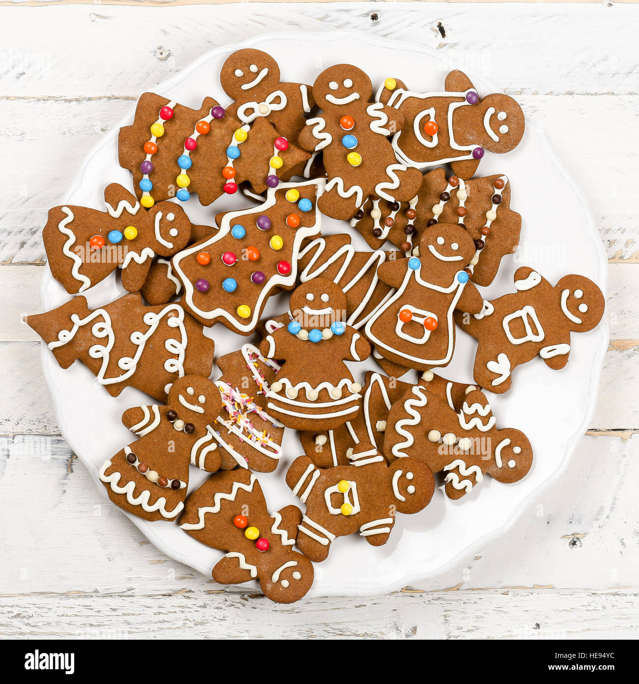 Christmas homemade gingerbread man family cookies couples on white wooden table background Stock Photo