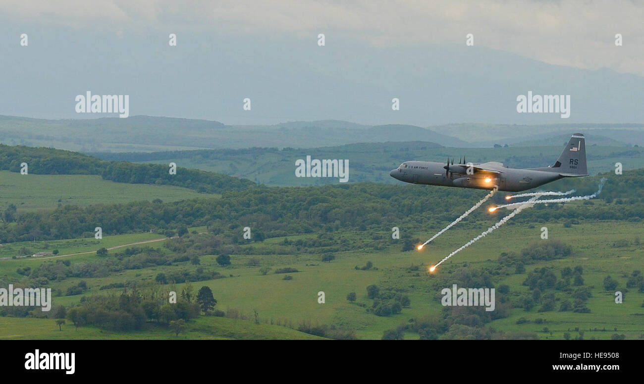 A C-130J Super Hercules from the 37th Airlift Squadron fires flares as it performs anti-aircraft fire tests during exercise Carpathian on May 9, 2016, in Romania. The 37th AS, from Ramstein Air Base, Germany, began participating in off-station training deployments with Romania as early as 1996, allowing the U.S. Air Force to work with NATO allies to develop and improve ready air forces capable of maintaining regional security. Airman 1st Class Lane Plummer Stock Photo