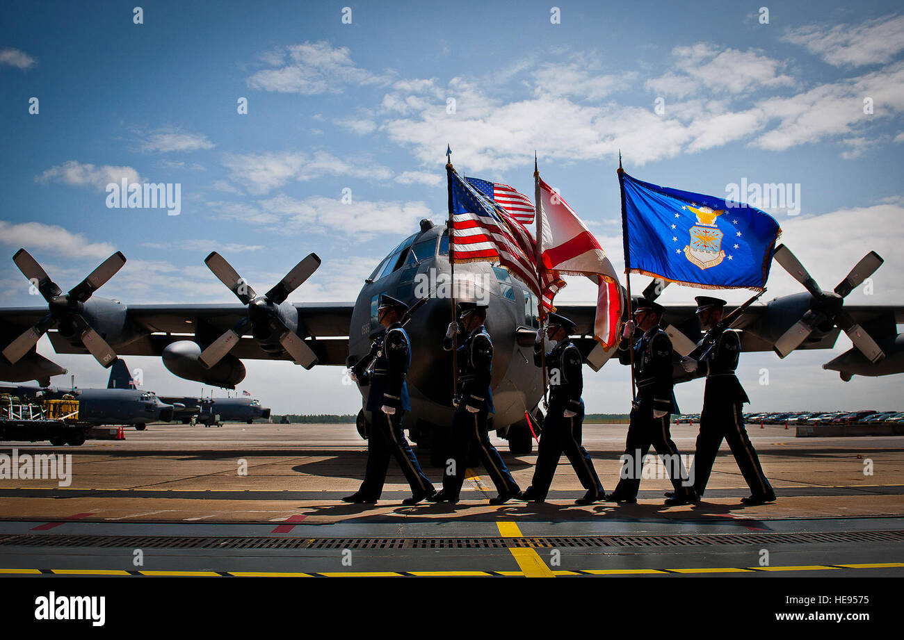 The Eglin Air Force Base Honor Guard brings in the colors in the shadow of an MC130E Combat