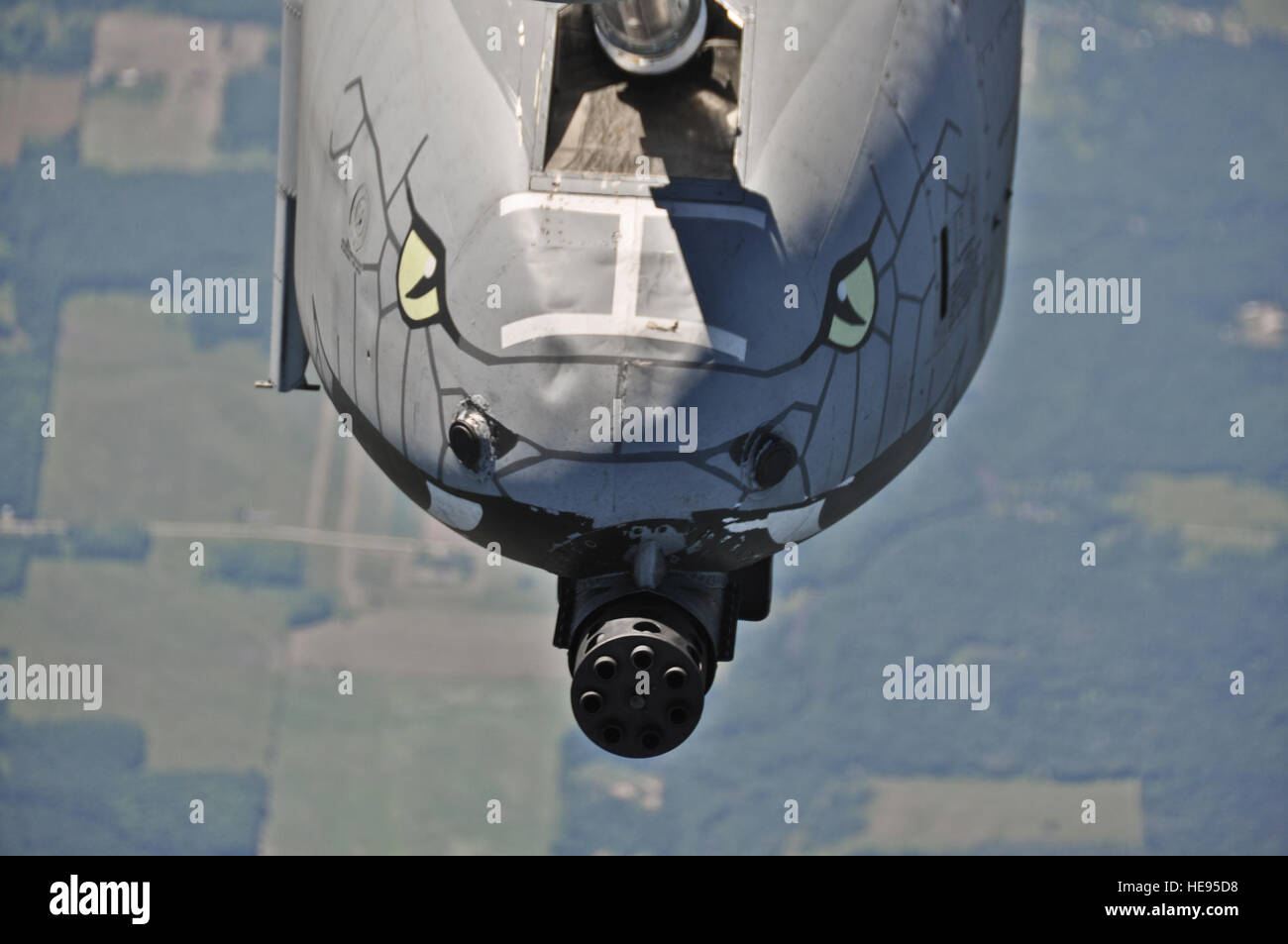 An A-10 Thunderbolt II from Selfridge Air National Guard Base, MI, displaying serpentine noseart around the 30 mm GAU-8/A Gatling Gun while being mid-air refueled during a boss lift and training flight over Michigan on July 11, 2012. The A-10 host an assortment of armament, with the GAU-8/A cannon able to dispense 3,900 rounds per minute. : Staff Sgt. Jeremy M. Wilson Stock Photo
