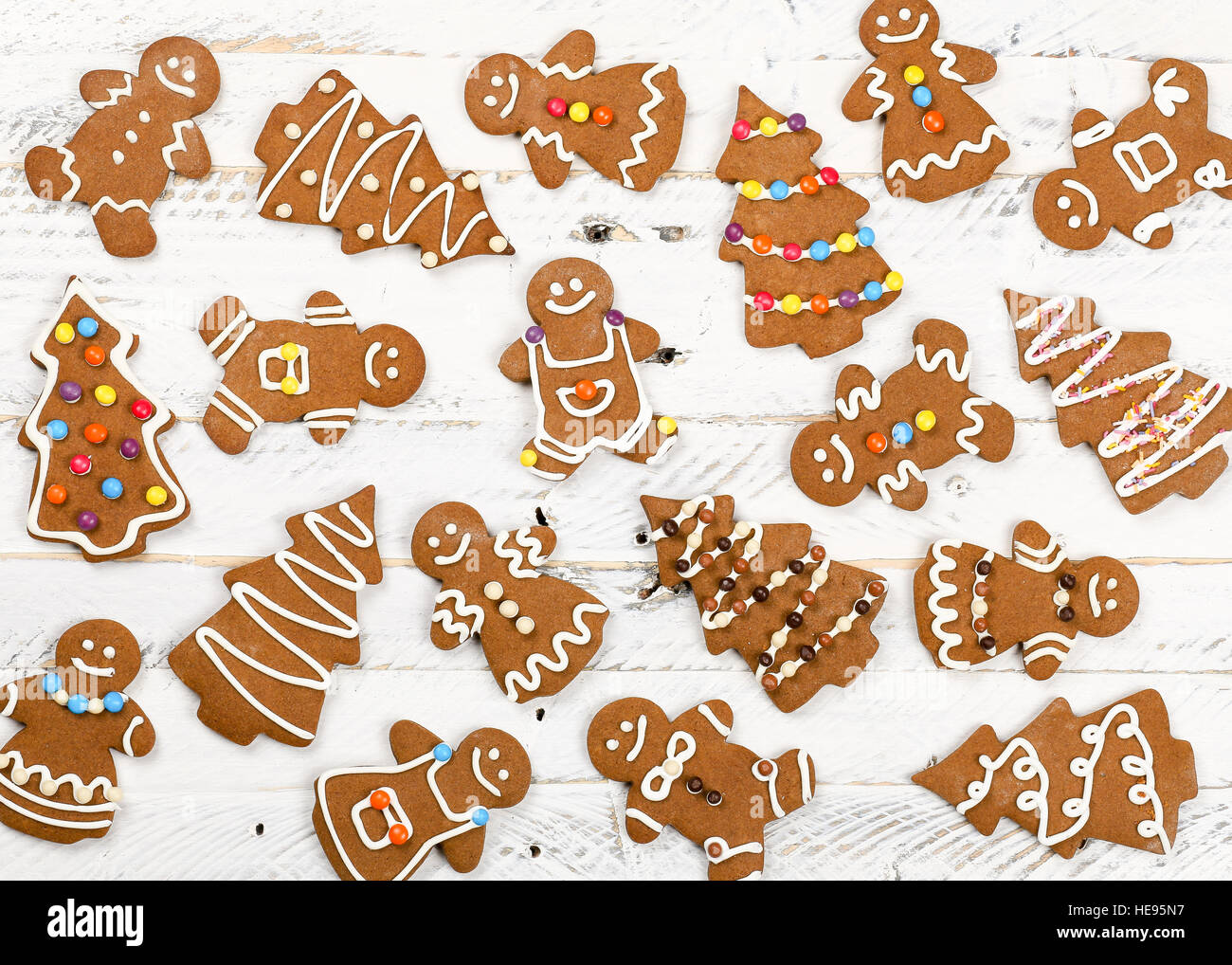 Christmas homemade gingerbread man family cookies couples on white wooden table background Stock Photo