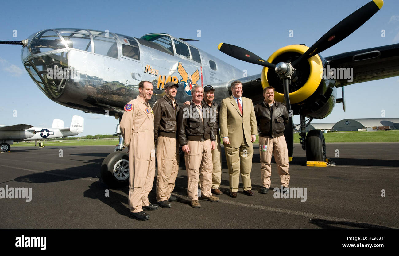 Secretary of the Air Force Michael Donley poses for a photo with the crew of B-25A 'Miss Hap.' It is one of 17 B-25s that have gathered for display and a formation fly-over the next day. 'Miss Hap' is the fourth B-25 off the production line and was used as the transport plane for Lt. Col. James Doolittle's travel between Florida and Washington D.C., during the planing and training phase of the historic raid on Tokyo. Later, it became the transport plane for General Hap Arnold. Stock Photo