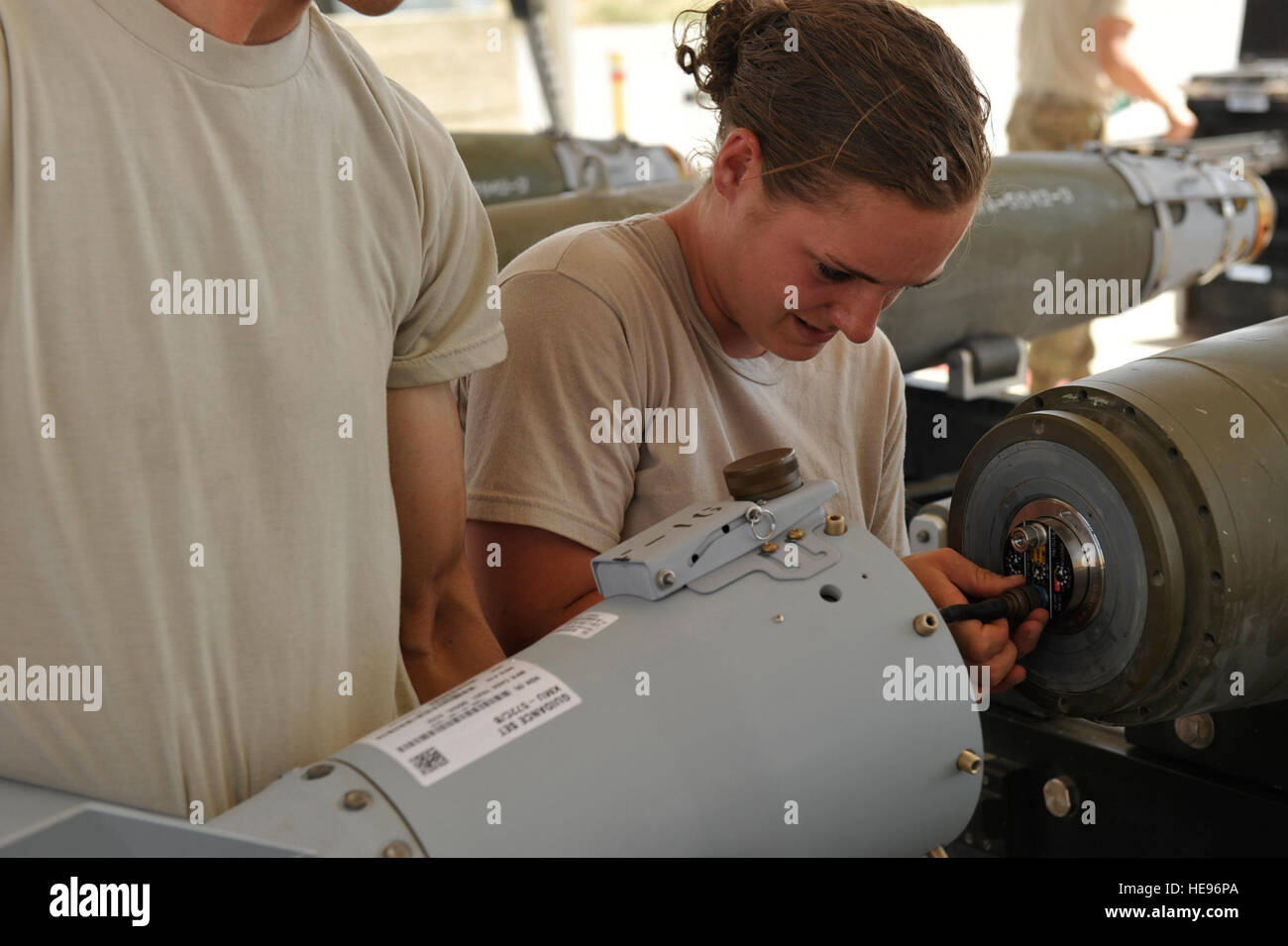 U.S. Air Force Airman 1st Class Casey Cain, a munitions systems technician currently assigned to the 455th Expeditionary Maintenance Squadron connects an FMU-152 tail fuse during a GBU-38 bomb build. GBU-38s are key weapons used on F-16C Fighting Falcons. Cain, a native of Unionville, Mo., is an Air Force reservist deployed from the 442nd Fighter Wing, Whiteman Air Force Base, Mo. She is part of a team of 10 munitions systems airmen from three U.S. bases are responsible for assembling bombs and ammunition that help keep U.S. ground forces safe throughout Afghanistan with A-10 and F-16 Close Ai Stock Photo