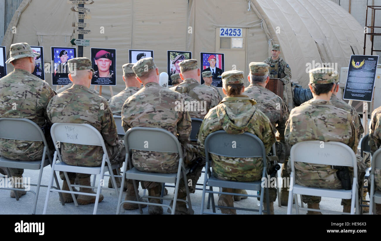 U.S. Air Force Master Sgt. Chris Young, 83rd Expeditionary Rescue Squadron, speaks to an assembly of service members during a remembrance ceremony honoring special operators who were killed March 4, 2002, during Operation Anaconda: U.S. Air Force Senior Airman Jason Cunningham, U.S. Army Cpl. Matthew Commons, U.S. Army Spc. Marc Anderson, U.S. Army Sgt. Phillip Svitak, U.S. Army Sgt. Bradley Crose, U.S. Navy Petty Officer 1st Class Neil Roberts and U.S. Air Force Tech. Sgt. John Chapman, March 3, 2015 at Bagram Air Field, Afghanistan. Service members from all branches conducted a 24-hour vigil Stock Photo