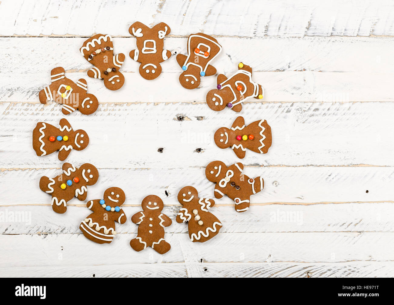Christmas homemade gingerbread man family cookies couples on white wooden table background, International friendship concept Stock Photo