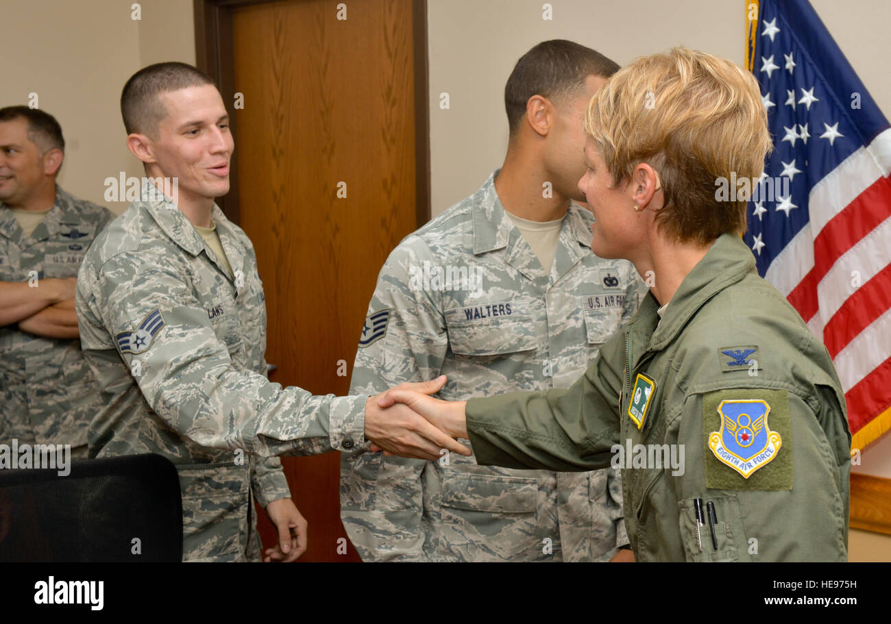 Col. Kristin Goodwin, 2nd Bomb Wing commander, welcomes home Senior Airman Brent Laws, 2nd Security Forces Squadron installation patrolman, at Barksdale Air Force Base, La., July 14, 2015. Laws returned home after a six-month deployment in support of Operations Inherent Resolve and Freedom’s Sentinel. Airman 1st Class Mozer O. Da Cunha) Stock Photo