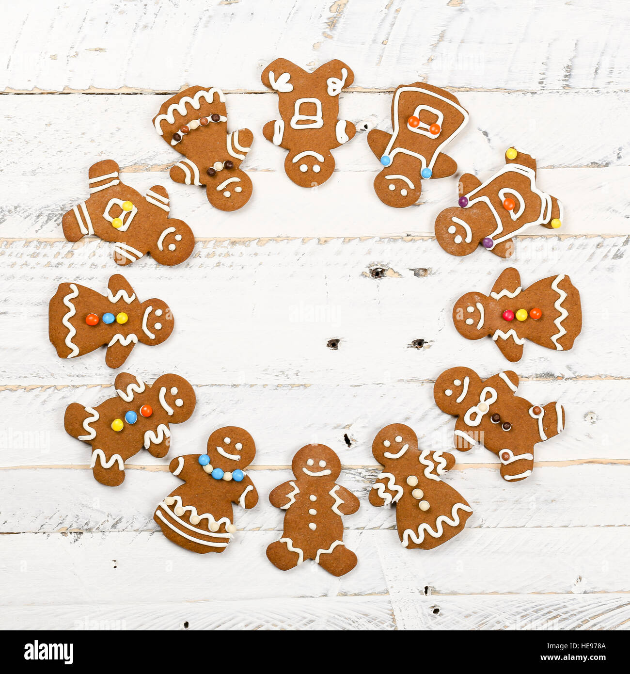 Christmas homemade gingerbread man family cookies couples on white wooden table background, International friendship concept Stock Photo