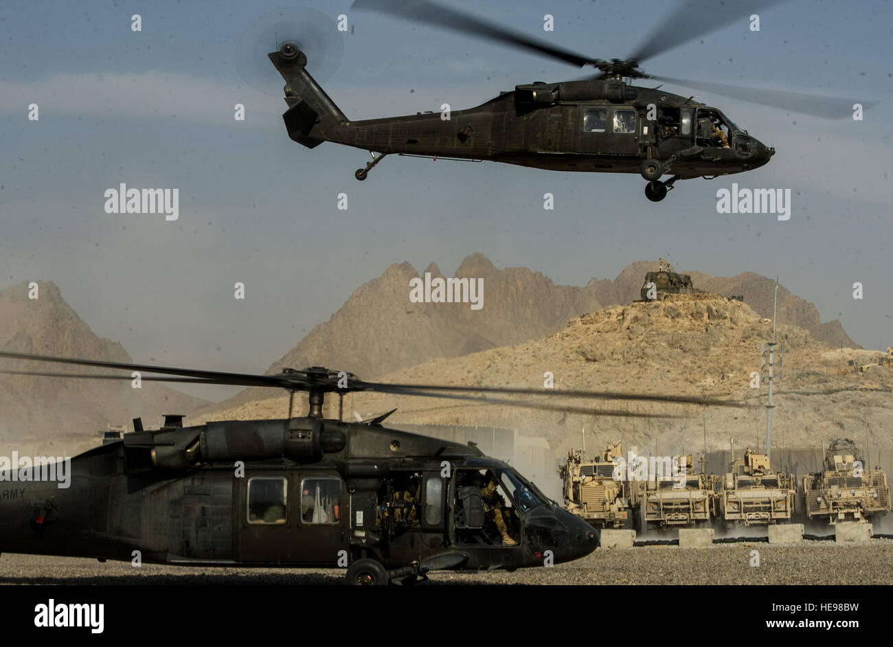 U.S. Army UH-60 Black Hawks takes off transporting troops to another location on Oct. 10, 2012, Forward Operating Base Masum Ghar, Afghanistan. The Black Hawk can perform a wide array of missions, including tactical transport of troops, electronic warfare, and aeromedical evacuation.  Staff Sgt. Jonathan Snyder)(NOT ) Stock Photo