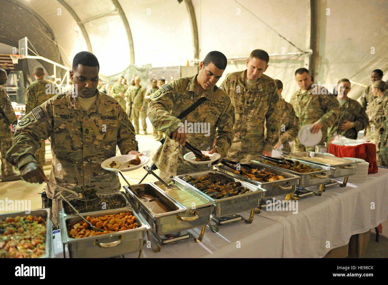 Service members at Bagram Airfield, Afghanistan, enjoy food served at the Black History Month luncheon, Feb. 22, 2014. Members from all branches and backgrounds came together for the celebration. Senior Master Sgt. Gary J. Rihn Stock Photo