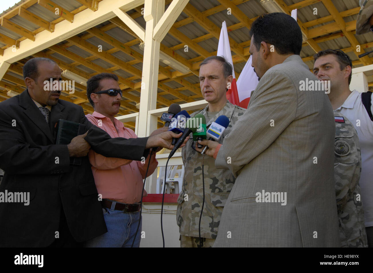 Polish Minister of Defense, Pan Bogdan Klich, center, is interviewed by members of the Iraqi media, at the conclusion of the End of Mission Ceremony for the Polish Multination Division Center ? South, Oct. 4, 2008, at Camp Echo, Iraq. Minister Klich commented on the successful cooperation between Polish and Iraqi forces and his optimism towards continued relations between Poland and a democratic Iraq.  Staff Sgt. Jessica Wilkes Stock Photo