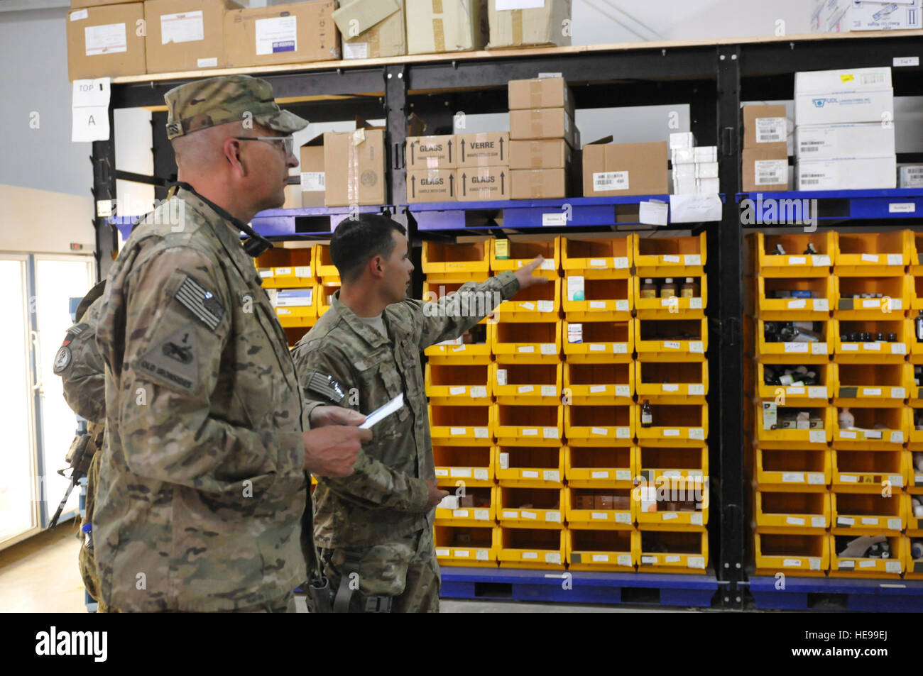 U.S. Air Force Senior Airman Jake Smith, right, the lead medical logistics advisor to the 2nd Forward Support Depot, gives a tour of a medical supply warehouse to U.S. Army Brig. Gen. Clark LeMasters, Jr., NATO Training Mission - Afghanistan's Deputy Commander of Supporting Operations commander, during a site visit at the Kandahar Regional Military Hospital in southern Afghanistan, May 28, 2012. LeMasters traveled from Kabul to assess logistics support for Afghan National Security Forces in southern Afghanistan. Stock Photo