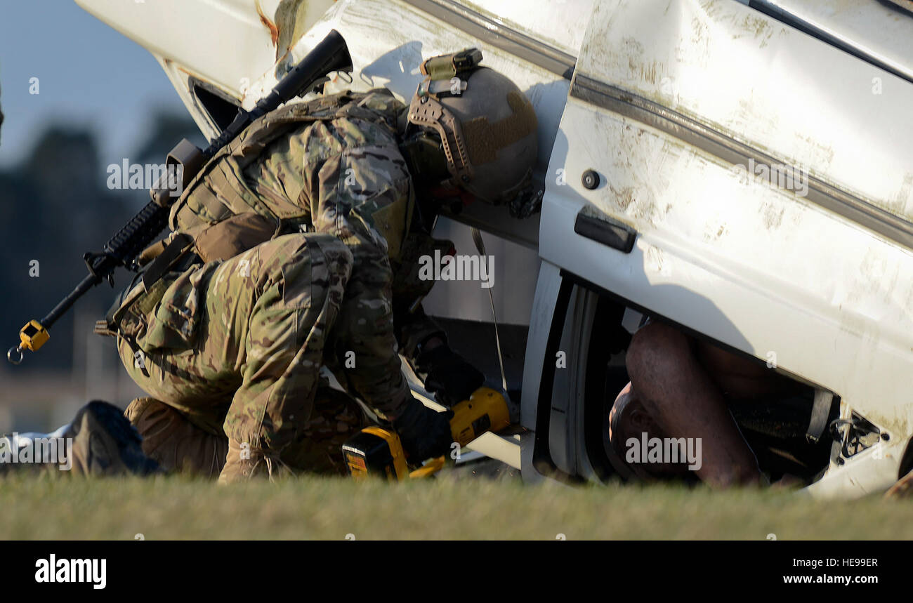 A pararescueman, assigned to the 56th Rescue Squadron, cuts open a car ...