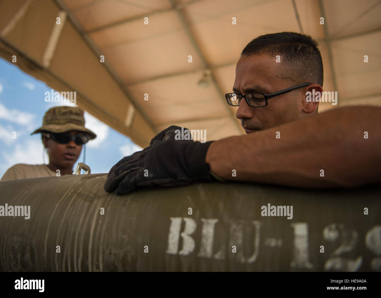Staff Sgt. Alejandro Medina, 455th Expeditionary Maintenance Squadron Munitions Flight munitions system specialist, helps build a GBU-54 munition at Bagram Airfield, Afghanistan, May 26, 2016. The munitions flight storage is responsible for the accountability of small arms ammunitions to large-scale guided bomb units.  Senior Airman Justyn M. Freeman) Stock Photo