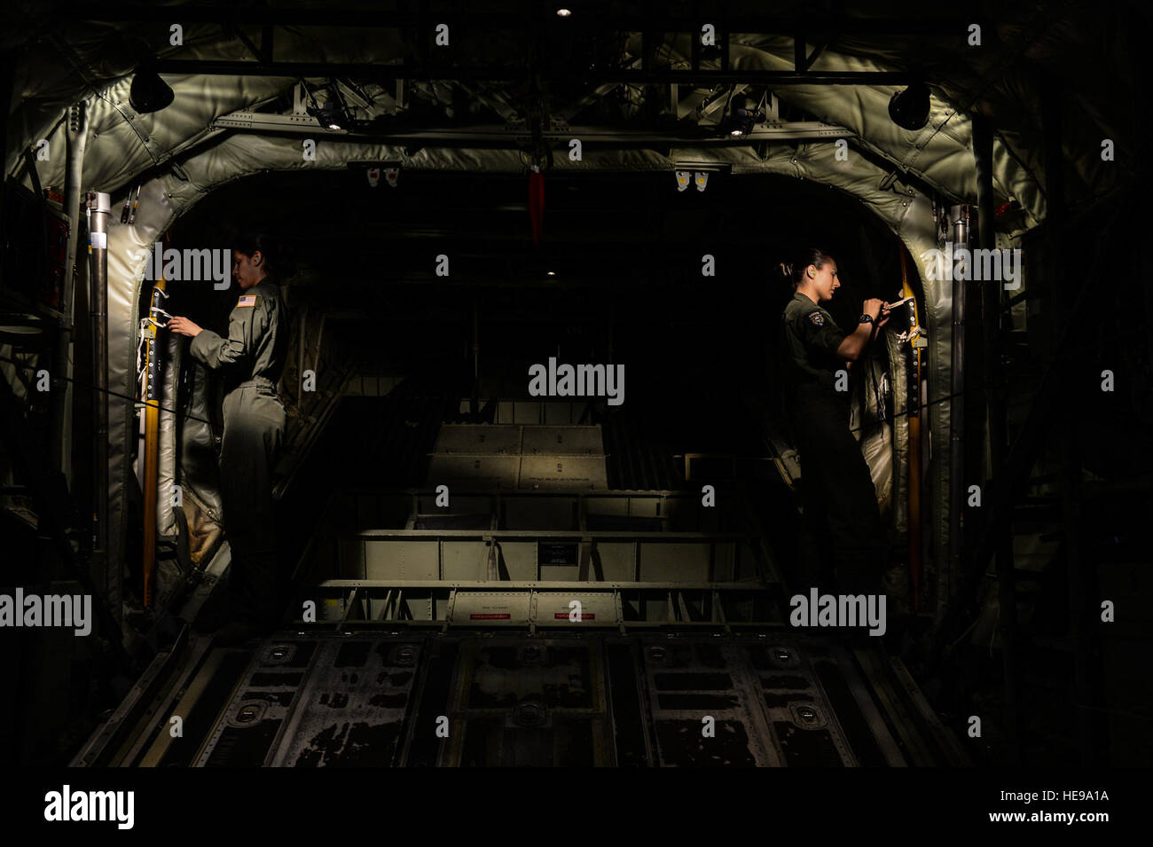 Senior Airmen Giselle Toro and Tristen Geray, 37th Airlift Squadron loadmasters, prepare for a U.S. and Bulgarian air force formation flight over Plovdiv, Bulgaria, July 14, 2015. Loadmasters are responsible for the proper loading of cargo onto an aircraft and ensuring passengers are safe and comfortable during travel. In addition to securing cargo, Toro and Geray were both responsible for the safe departure of paratroopers from the aircraft during the flight. Senior Airman Nicole Sikorski) Stock Photo