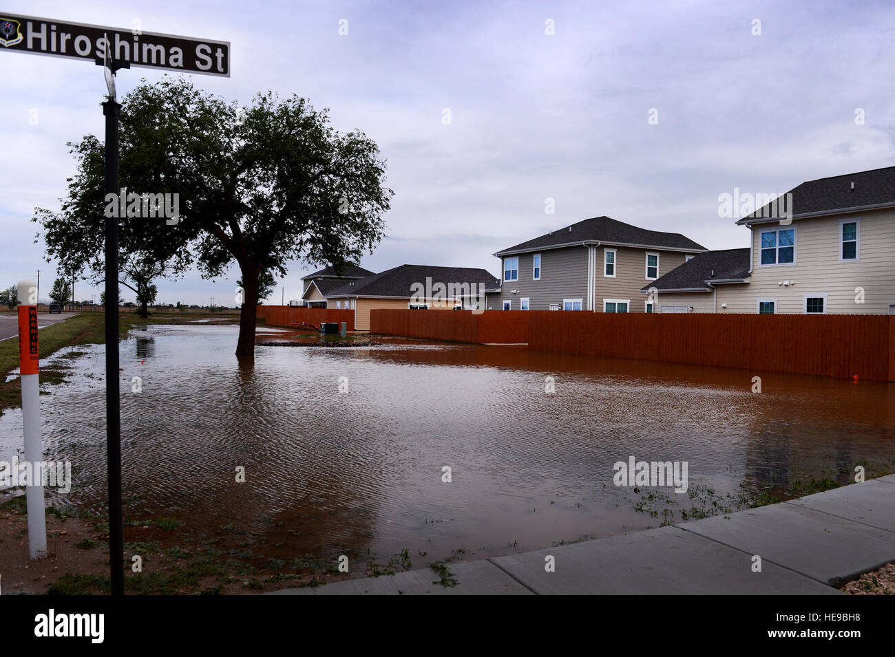 Flood water pools along homes after a severe weather storm May 5, 2015 at Cannon Air Force Base, N.M. Air commandos and their families weathered the brunt of a colossal storm that flooded homes and other base facilities. Staff Sgt. Matthew Plew) Stock Photo