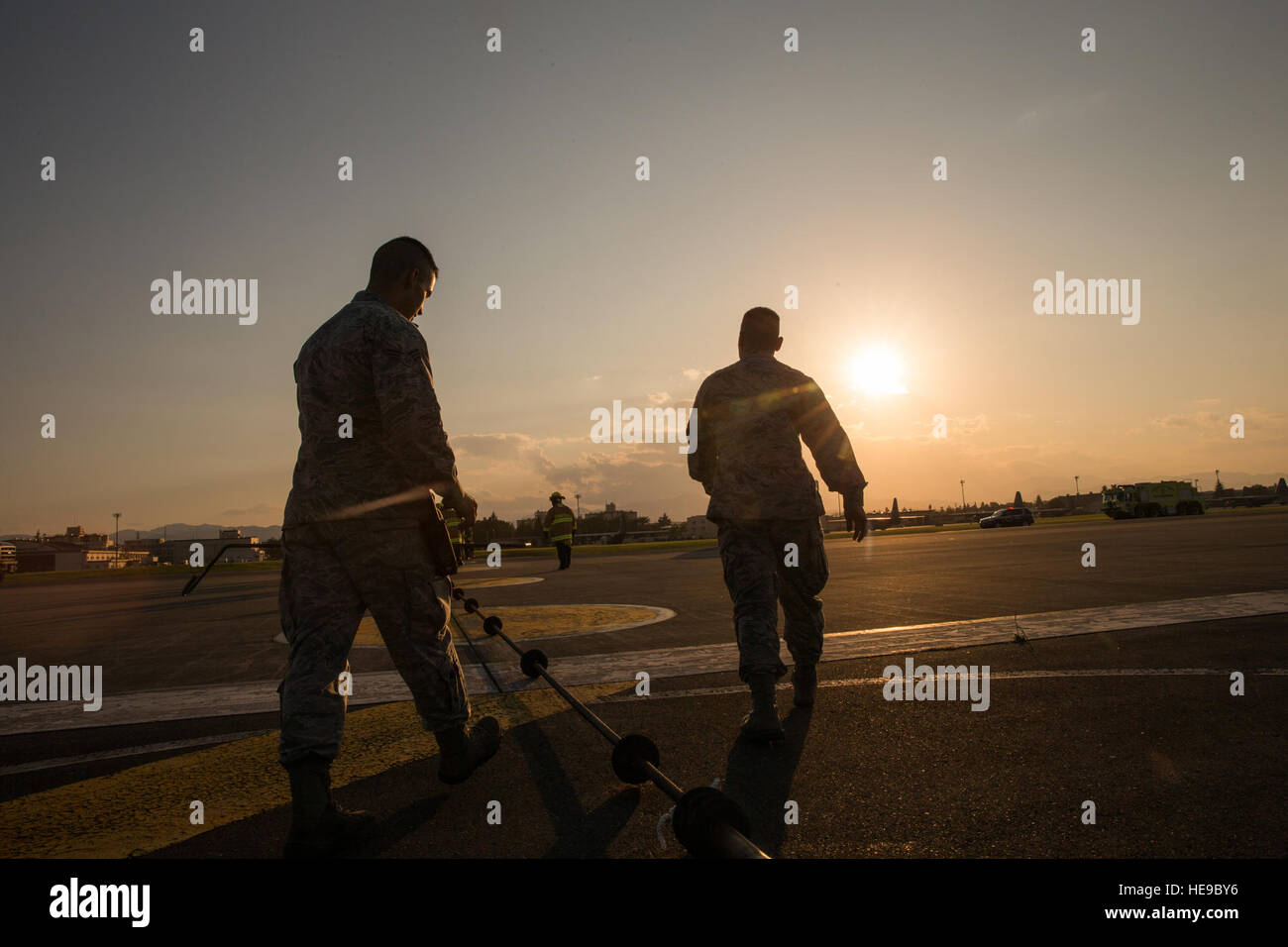 Airmen with the 374th Civil Engineer Squadron electrical power productions shop inspect an emergency aircraft landing cable on the runway at Yokota Air Base, Japan, June 3, 2016. The 374th Civil Engineer Squadron power productions shop, fire department and 374th Operations Support Squadron airfield management flight are responsible for testing the system annually.  Yasuo Osakabe Stock Photo