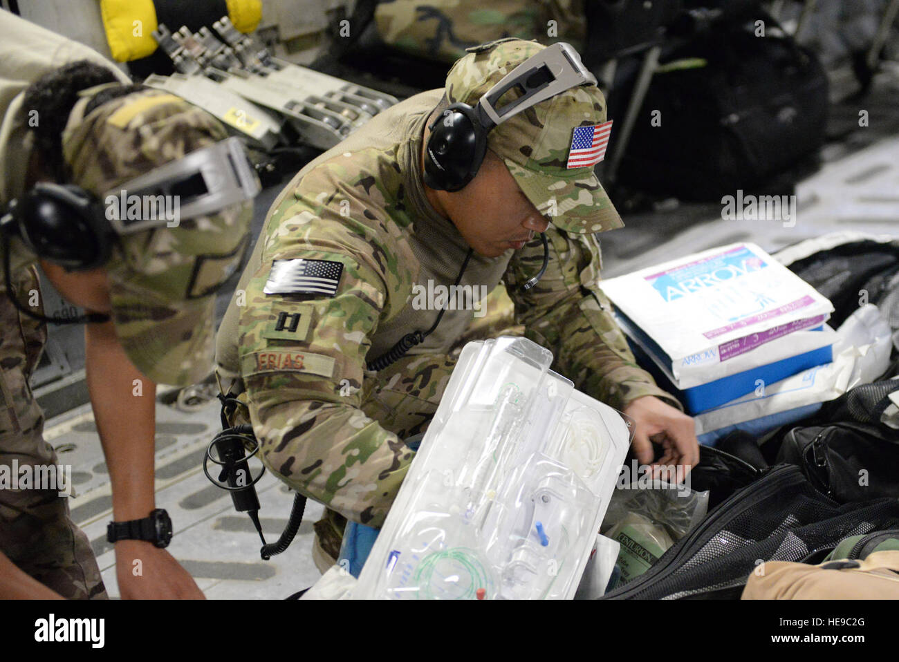 U.S. Air Force Capt. Jason Frias, 455th Expeditionary Aeromedical Evacuation Squadron Critical Care Air Transport Team critical care nurse deployed from the 60th Medical Group at Travis Air Force Base, Calif., checks in equipment bags for supplies during an aeromedical evacuation mission aboard a C-17 Globemaster III aircraft from Bagram Airfield, Afghanistan, to Ramstein Air Base, Germany, Aug. 9, 2015. The 455th EAES’ CCATT is a three-person, highly specialized medical team consisting of a physician who specializes in an area of critical care or emergency medicine, a critical care nurse and  Stock Photo