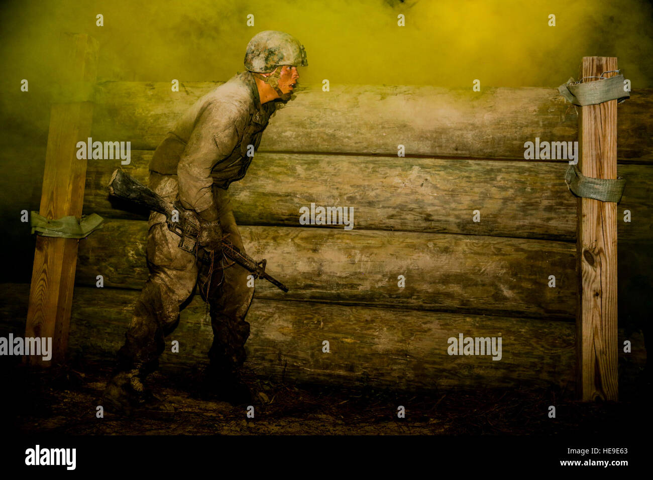 A Marine with 2nd Combat Engineer Battalion prepares to clear a log wall during the Night Infiltration Course on Marine Corps Base Camp Lejeune June 23, 2016. The course challenged Marines ability to communicate and move in a combat scenario to accomplish the mission. Stock Photo