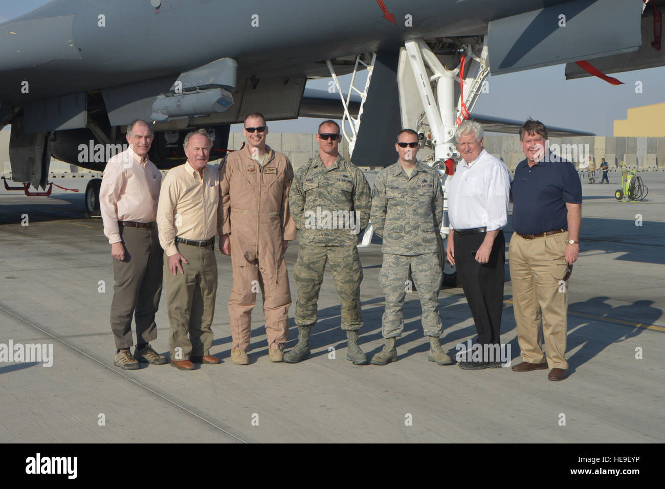 Cong. Peter Visclosky (D-Ind.), Rodney Frelinghuysen (R-N.J.), James Moran (D-Va.) and Ken Calvert (R-Calif.) from the House of Appropriations Committee pose in front of a B1-B Lancer with airmen from the 37th Expeditionary Bomb Squadron at Al Udeid Air Base, Qatar, Feb. 18, 2014. The congressmen visited five Air Force airframes deployed here and were briefed on the capability of multiple units on base who support the U. S. Air Forces Central Command area of responsibility and Operation Enduring Freedom. The congressmen also had lunch with Airmen who are from their represented state to discuss Stock Photo