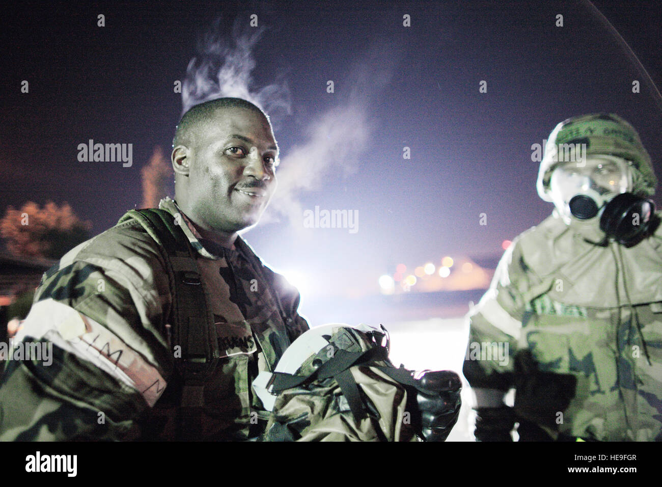With the exercise complete, Staff Sgt. Sadiq Stevens shows the temperature difference as steam rises after removing his gas mask April 1, 2010, at Yokota Air Base, Japan.  Yokota Airmen conducted an exercise recently to help maintain operational readiness. Sergeant Stevens is assigned to the 374th Operation Support Squadron.  Osakabe Yasuo) Stock Photo